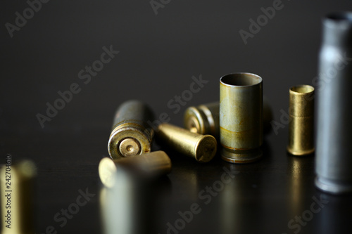 Empty old bullet cartridges on a dark background close up