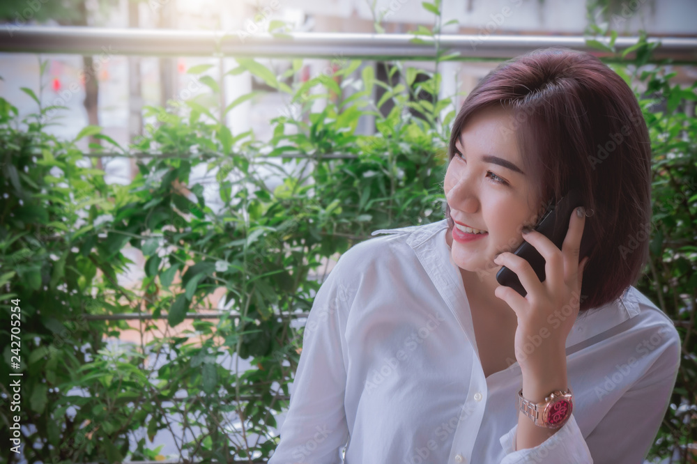 happy girl's smiling and using telephone mobile , talking smart phone on the nice day happy girl's smiling and using telephone mobile , talking smart phone on the nice day