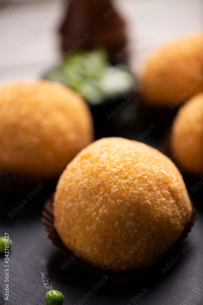 Arancini rice and meat dish on black Arancini rice and meat dish on black