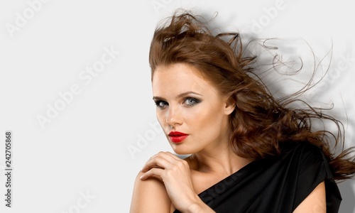 Portrait of beautiful young woman with brown hair and make-up