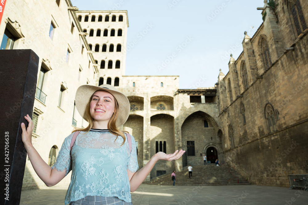 Young woman in hat standing outdoors in historical city center