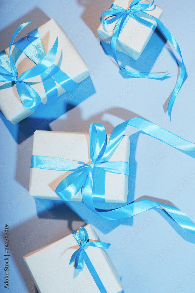 gifts on a blue background with a blue ribbon isolate pradnik prepare a surprise for a girl box design homemade bright blue color gifts on a blue background with a blue ribbon isolate pradnik prepare a surprise for a girl box design homemade bright blue color