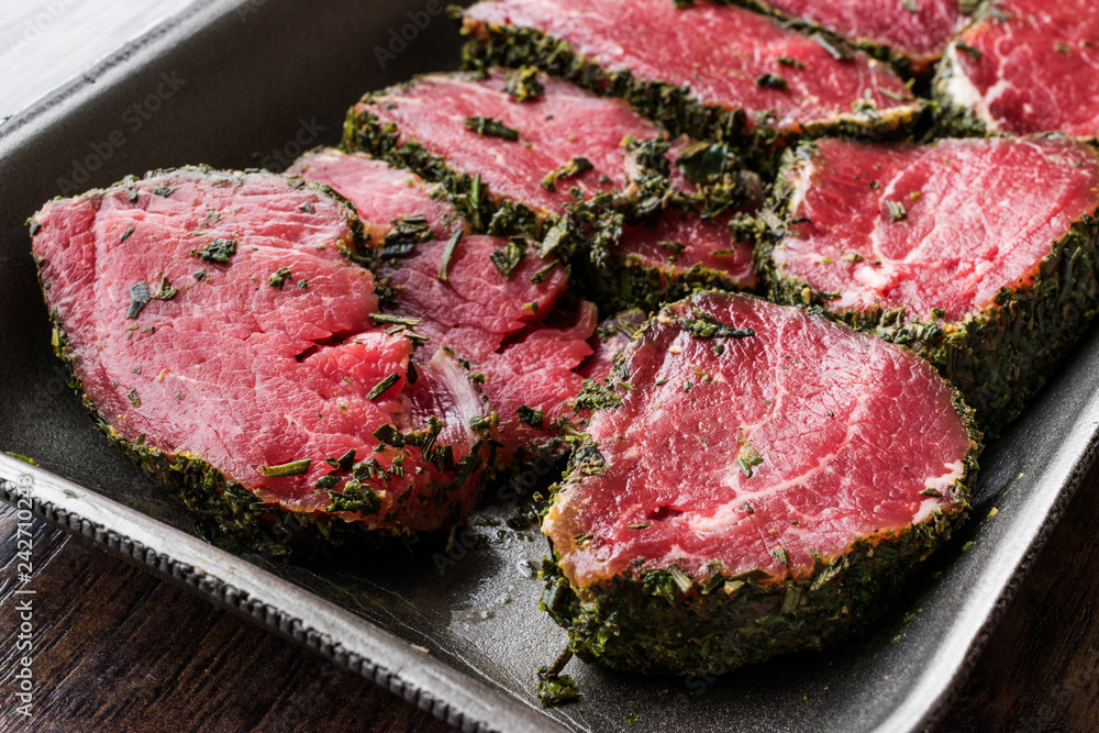 Package of Raw Tenderloin Meat with Herbs and Spices in Plastic Box / Container. Package of Raw Tenderloin Meat with Herbs and Spices in Plastic Box / Container.
