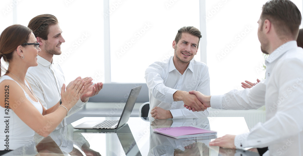 Obraz premium handshake business partners over the Desk