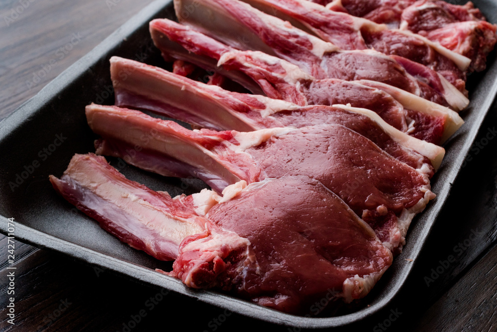 Fototapeta premium Package of Raw Lamb Chops Meat in Plastic Box / Container.