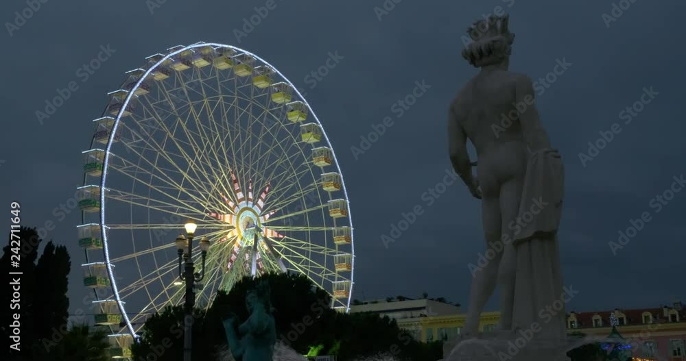 Watching the colorful light show on a ferris wheel with the Statue of ...