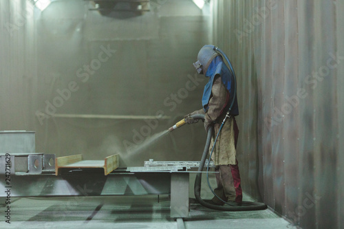 Sandblast. Blasting metal.