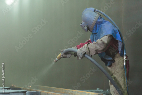 Sandblast. Blasting metal.