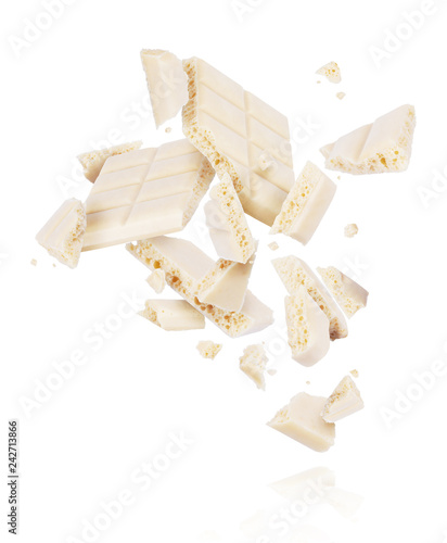 Obraz na plátně Broken porous white chocolate fall down isolated on white background