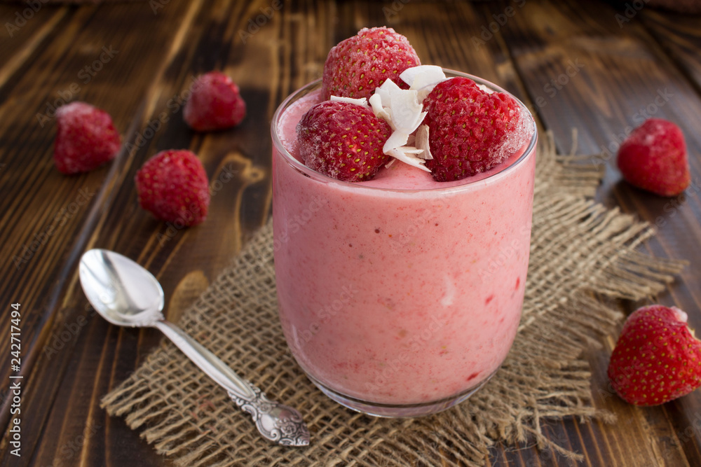 Yogurt with frozen strawberry on the rustic wooden background Yogurt with frozen strawberry on the rustic wooden background