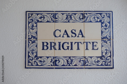 Blue white Portuguese tiles, Azulejos, with the name of a house: "CASA BRIGITTE", blue letters and patterns on white background. - Images