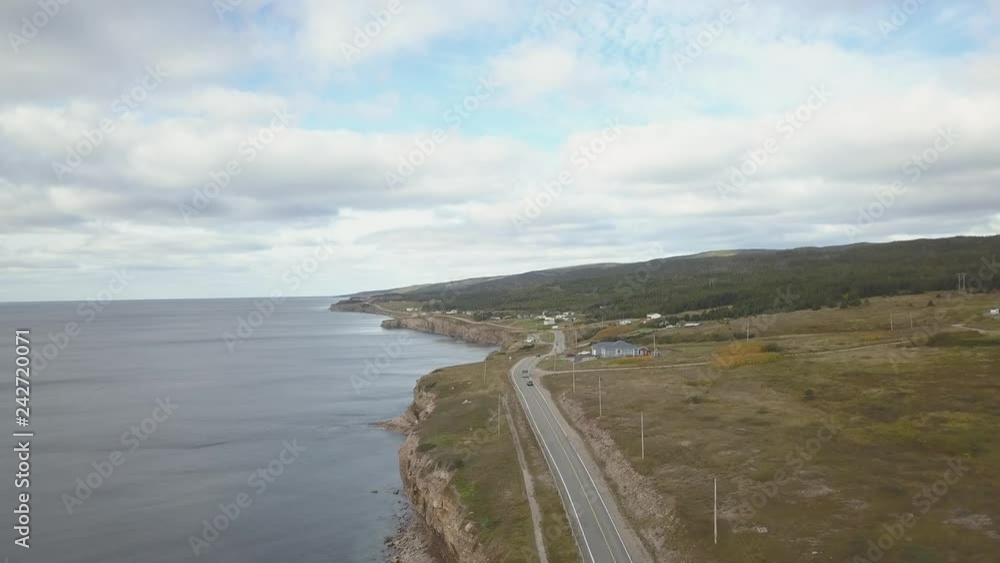 Aerial landscape view of a scenic road on the Atlantic Ocean Coast during a sunny day. Taken in Port au Port West-Aguathuna-Felix Cove, Newfoundland, Canada. Aerial landscape view of a scenic road on the Atlantic Ocean Coast during a sunny day. Taken in Port au Port West-Aguathuna-Felix Cove, Newfoundland, Canada.