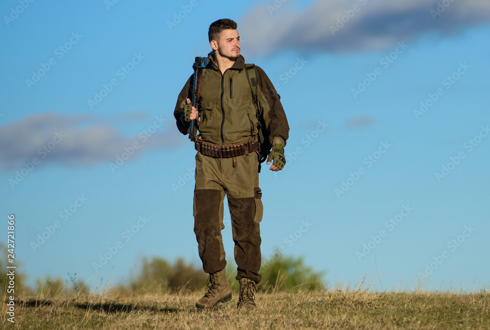 Experience and practice lends success hunting. Hunting hobby. Guy hunting nature environment. Masculine hobby activity. Hunting weapon gun or rifle. Man hunter carry rifle blue sky background