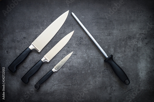 Knives and sharpener on the table.