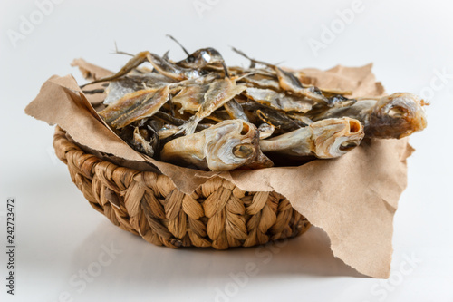 Assorted dried fish in a basket on craft paper