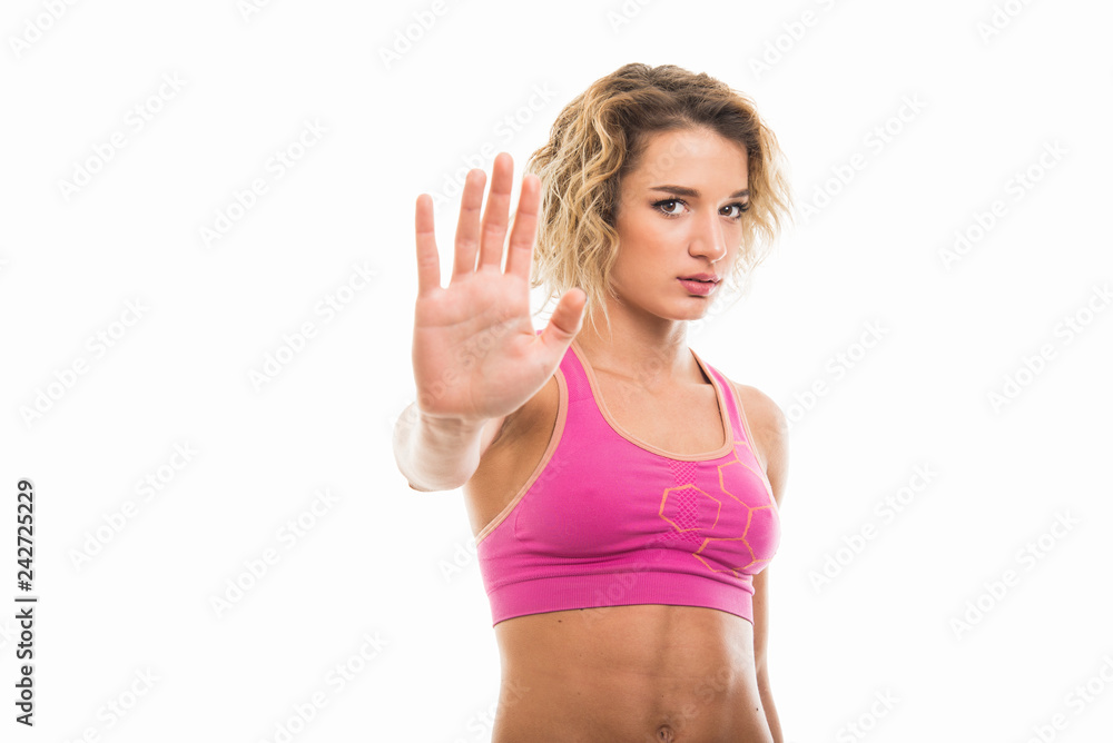 Portrait of beautiful young fit girl showing stop gesture Portrait of beautiful young fit girl showing stop gesture