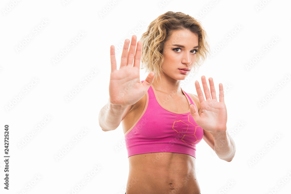 Portrait of beautiful young fit girl showing stop gesture Portrait of beautiful young fit girl showing stop gesture