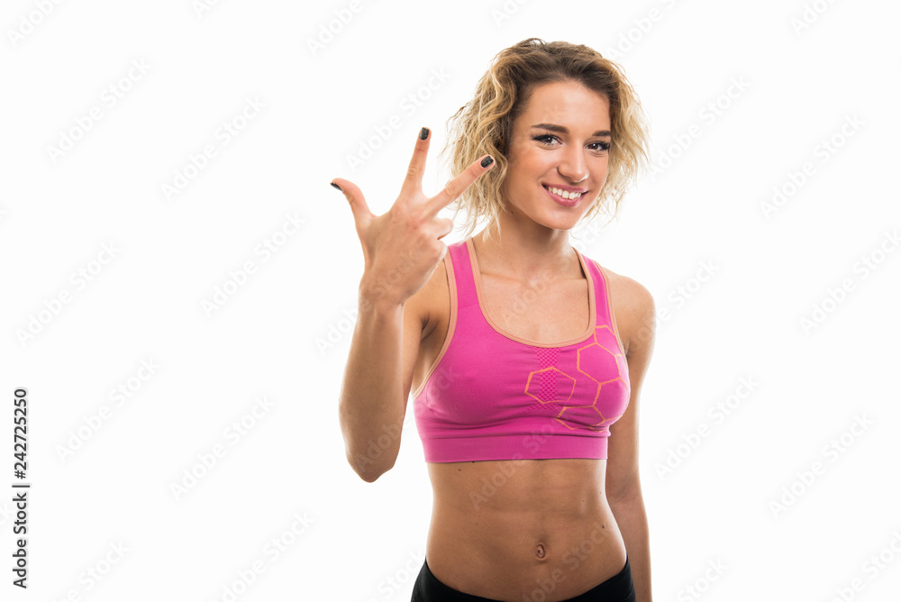 Portrait of beautiful young fit girl showing number three Portrait of beautiful young fit girl showing number three