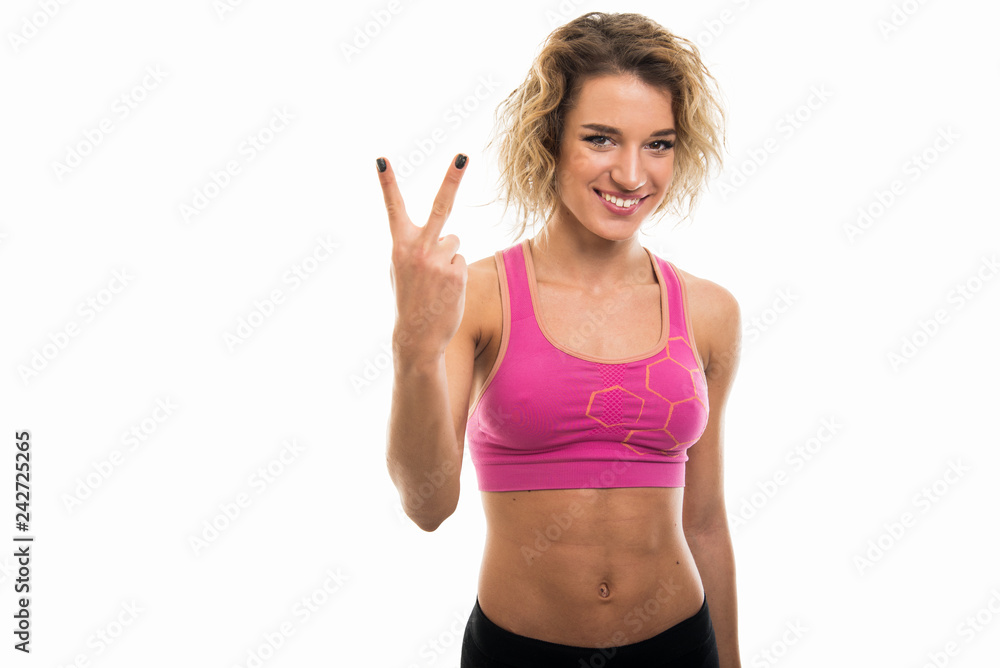 Portrait of beautiful young fit girl showing number two Portrait of beautiful young fit girl showing number two