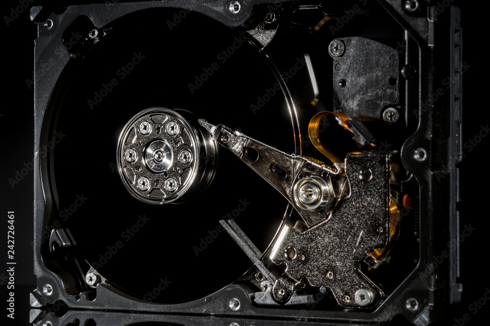 Disassembled and opened hard disk drive, inside view with reflections, isolated on black Disassembled and opened hard disk drive, inside view with reflections, isolated on black