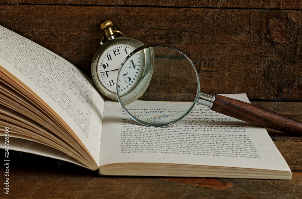 Pocket clock, book and magnifying glass Pocket clock, book and magnifying glass