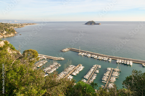 Panoramic view from above of the harbor of Alassio, the Gallinara Island and the coastal city of Albengain the background, Liguria, Italy