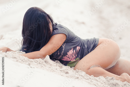 Beautiful athletic sensual woman on sand