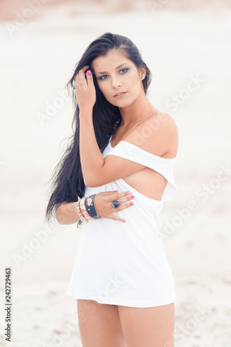 Seductive young woman posing in white shirt