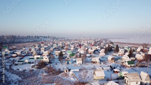 4k aerial photography. Winter landscape on the village. Warm sunset light.