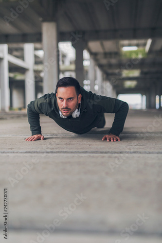 Running man doing push ups. © Jelena