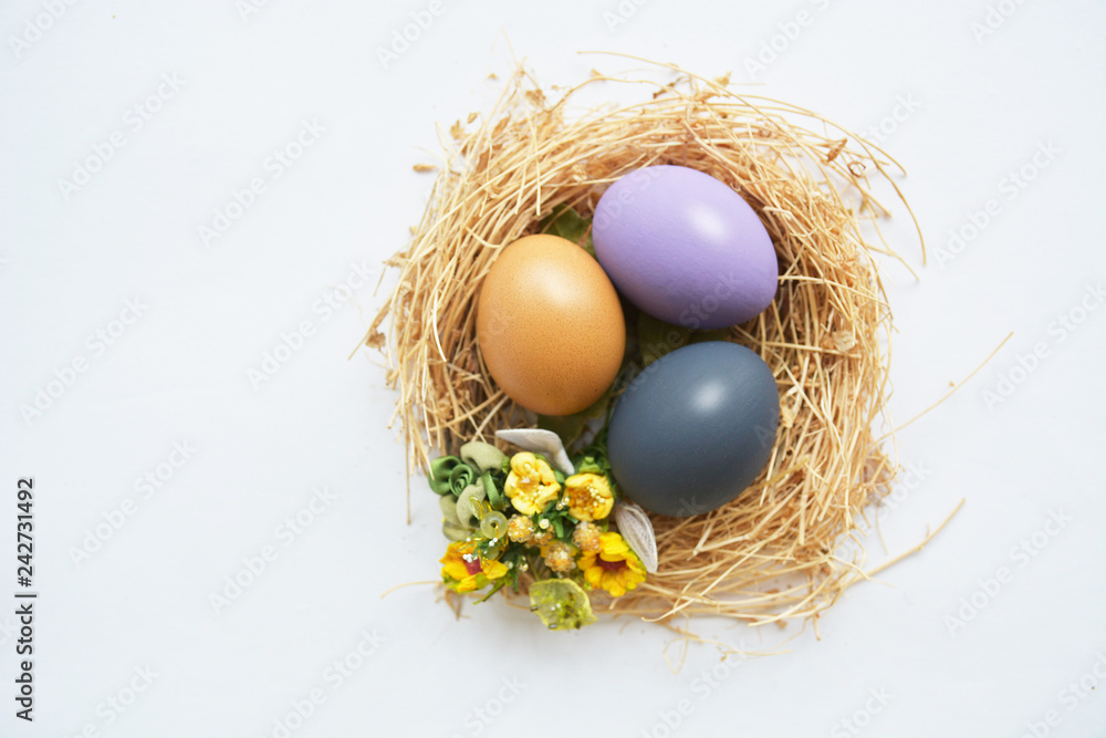 colored Easter eggs in nest on wooden background, selective focus image. Happy Easter card colored Easter eggs in nest on wooden background, selective focus image. Happy Easter card