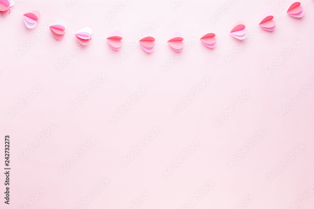Colorful paper garland of hearts on the living coral background. Valentine day greeting cards. Colorful paper garland of hearts on the living coral background. Valentine day greeting cards.