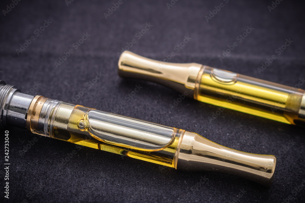 THC/CBD Cannabis Oil & Terpenes Filled Cartridges Isolated Up Close On Black THC/CBD Cannabis Oil & Terpenes Filled Cartridges Isolated Up Close On Black