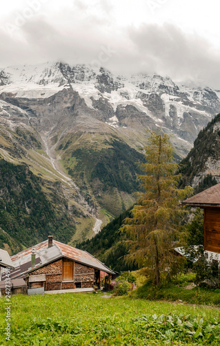 Wooden houses in the Murren mountains in Switzerland on a cloudy day © Tomas