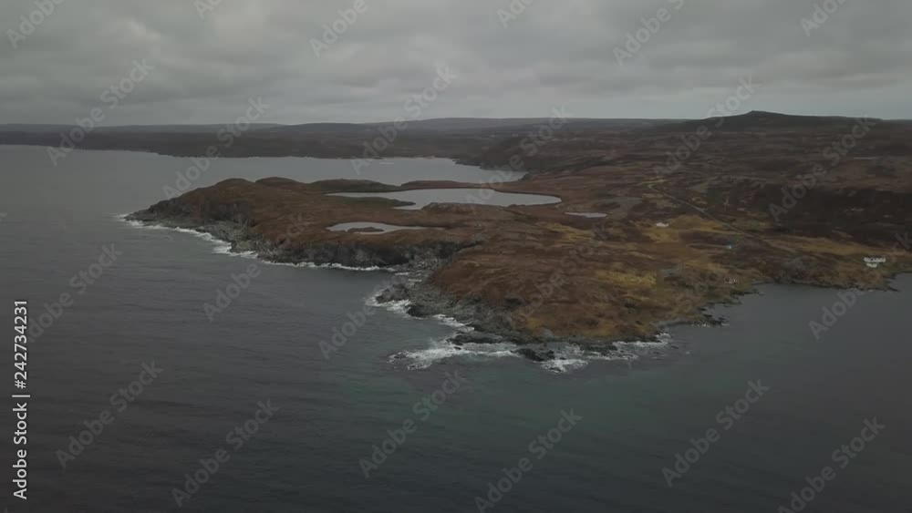 Aerial panoramic view of a small town on a rocky Atlantic Ocean Coast during a cloudy day. Taken Newfoundland, Canada. Aerial panoramic view of a small town on a rocky Atlantic Ocean Coast during a cloudy day. Taken Newfoundland, Canada.