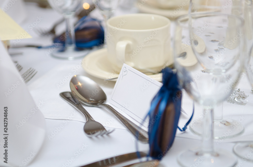 An empty blank paper table card name plate sign on a wedding table, shot with a shallow depth of field. perfect for placing names in composite designs. An empty blank paper table card name plate sign on a wedding table, shot with a shallow depth of field. perfect for placing names in composite designs.