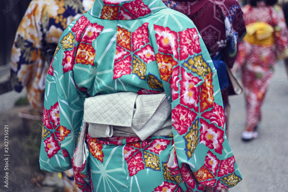 Rear view of women in kimono walking outdoors Rear view of women in kimono walking outdoors