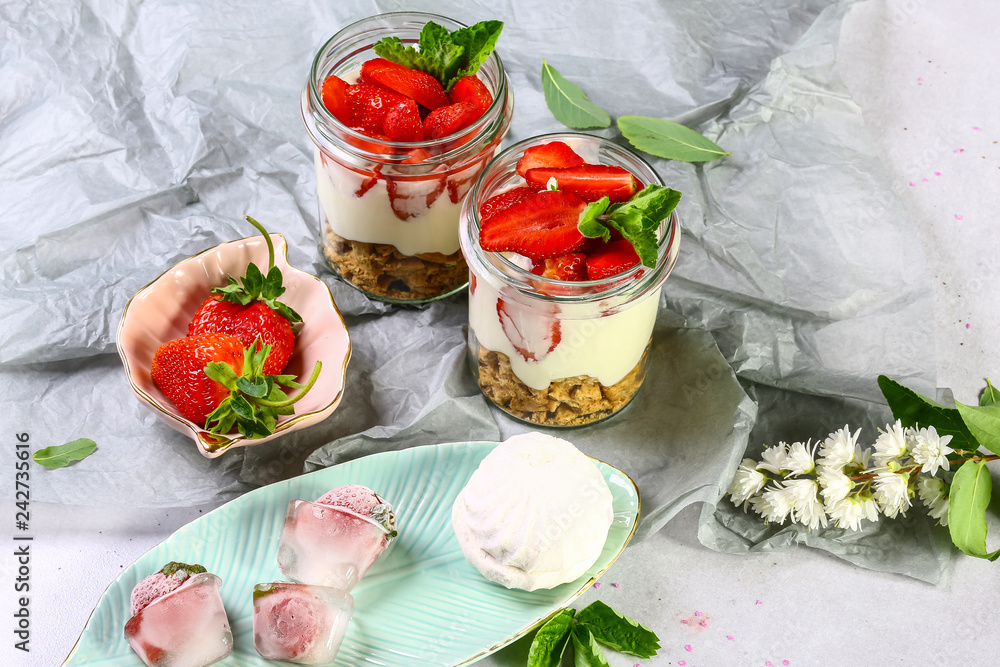 Dessert with fresh strawberries with whipped cream and mint on a rustic wood background Dessert with fresh strawberries with whipped cream and mint on a rustic wood background