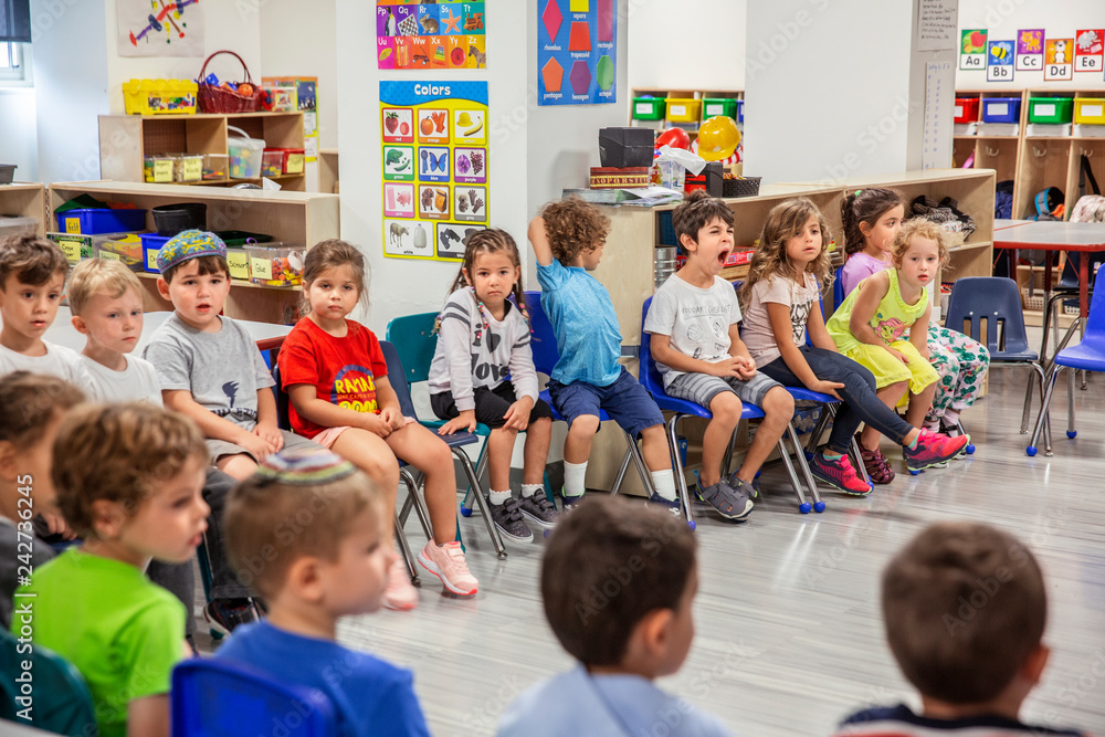Foto Stock Children sitting in circle in classroom Adobe Stock