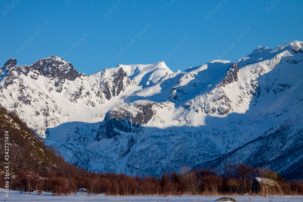 Fototapeta premium Mountains in winter, The mountain Møysalen in 1264 over the sea in Hadsel municipality, Nordland county