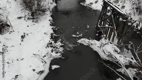 Above the river, winter time. Near the ruins of the old bridge. Smooth fly forward and down technique
