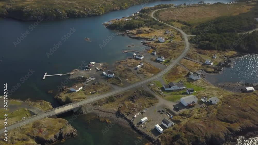 Aerial view of a small town on a rocky Atlantic Ocean Coast during a cloudy day. Taken in Pikes Arm, Newfoundland, Canada. Aerial view of a small town on a rocky Atlantic Ocean Coast during a cloudy day. Taken in Pikes Arm, Newfoundland, Canada.
