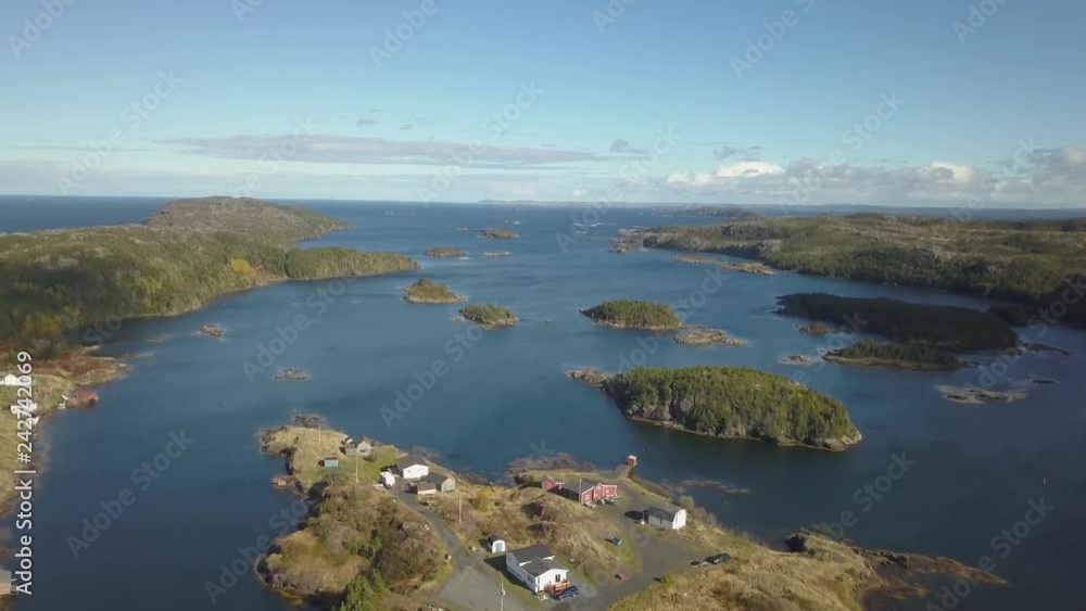 Aerial view of a small town on a rocky Atlantic Ocean Coast during a cloudy day. Taken in Pikes Arm, Newfoundland, Canada. Aerial view of a small town on a rocky Atlantic Ocean Coast during a cloudy day. Taken in Pikes Arm, Newfoundland, Canada.