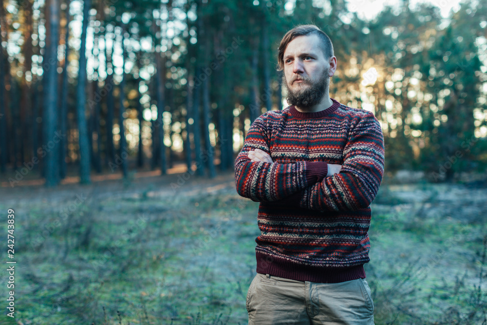 Portrait brutal bearded hipster man in the forest Portrait brutal bearded hipster man in the forest