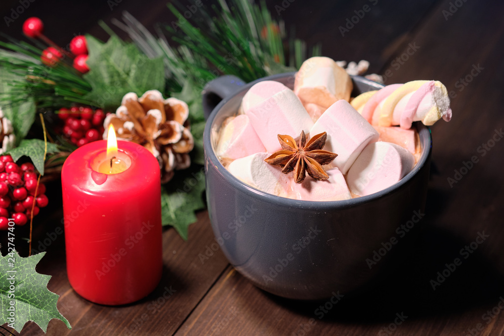  marshmallow in grey cup on brown wood background with Christmas tree ,  candles and christmas lights