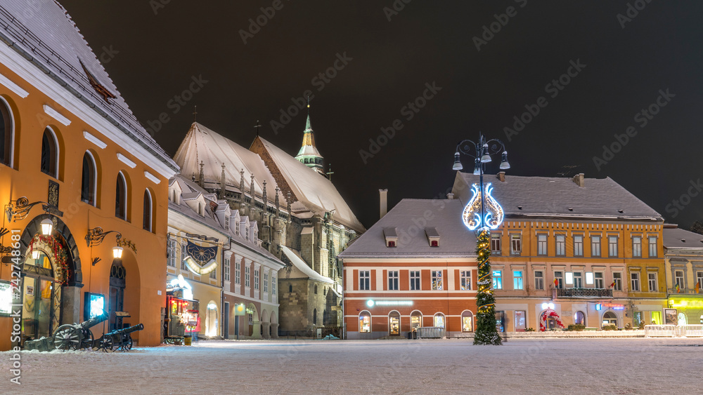 Fototapeta premium Brasov, Romania. Black Church in the old town square (Piata Sfatului) covered with snow. Brasov, probably the best town in the world.