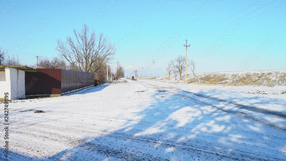Winter road in the village. Empty country road. Rural winter landscape. View of the surroundings. The village in the Kherson region, Ukraine. Winter road in the village. Empty country road. Rural winter landscape. View of the surroundings. The village in the Kherson region, Ukraine.