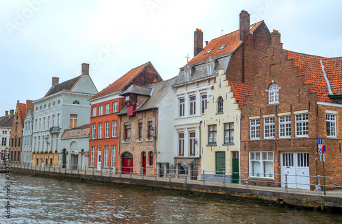 Streets of Bruges in Belgium with its medieval style facades on a cloudy day.