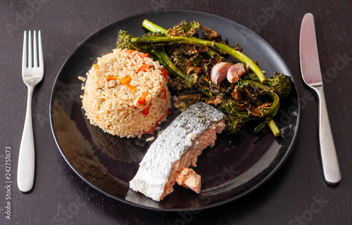 Salmon fillet served with brown rice and roasted tenderstem broccoli