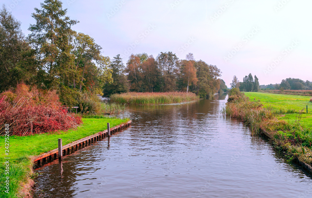 Giethoorn, village of Holland with canals and rural houses on a cloudy day Giethoorn, village of Holland with canals and rural houses on a cloudy day
